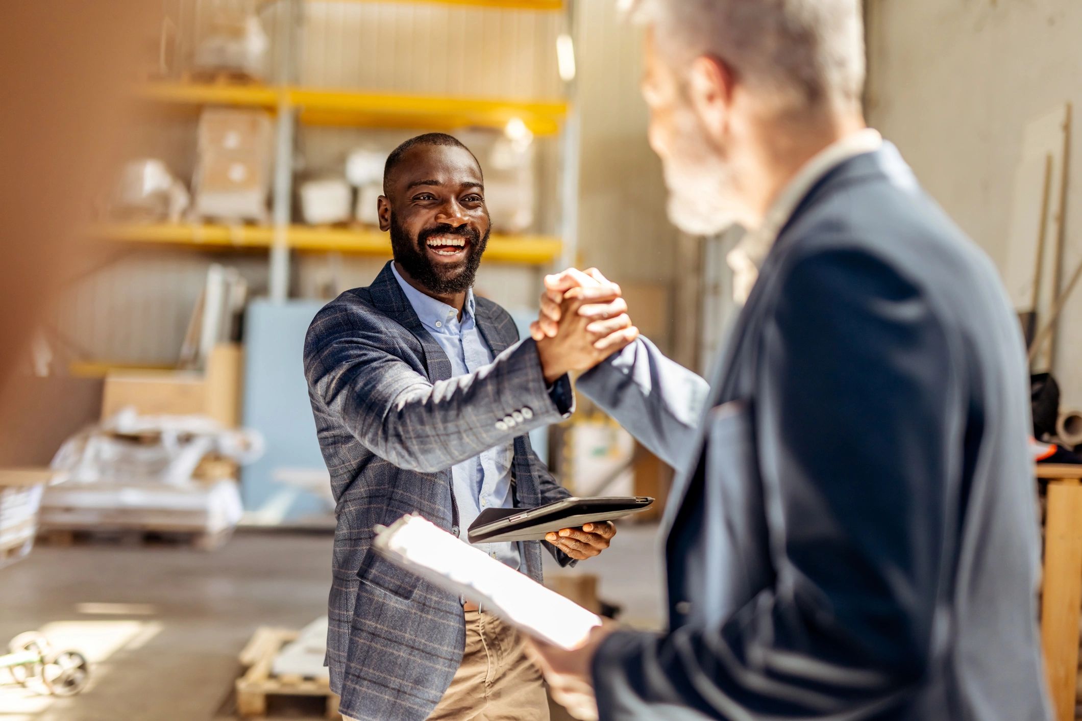 Homeowner and contractor shaking hands after a consultation